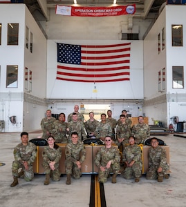 Members assigned to the 374th Air Expeditionary Wing combat mobility flight pose for a photo.