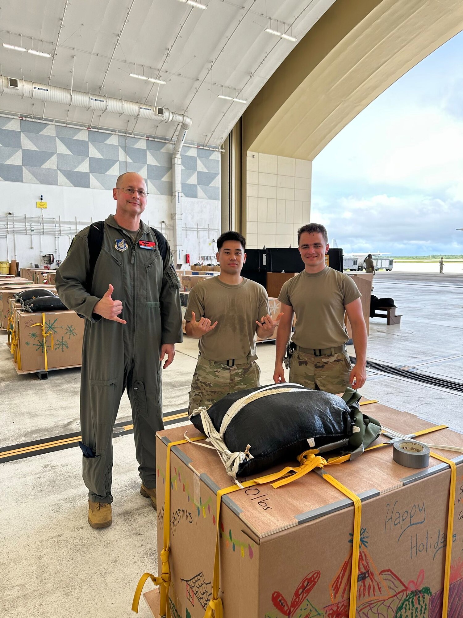 From left, U.S. Air Force Col. Richard McElhaney, 374th Airlift Wing commander, Senior Airman Joshua Gakud and Airman 1st Class Alexandr Lepekhin, 374th Air Expeditionary Wing combat mobility flight combat mobility technicians, pose for a photo