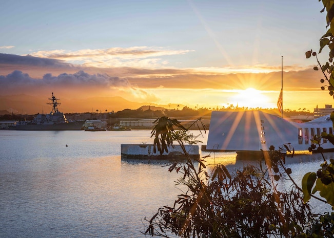 The Arleigh Burke-class guided-missile destroyer USS Carl M. Levin (DDG 120) conducts a pass-in-review during the 84th National Pearl Harbor Remembrance Day ceremony at the Pearl Harbor National Memorial Dec. 7, 2025.