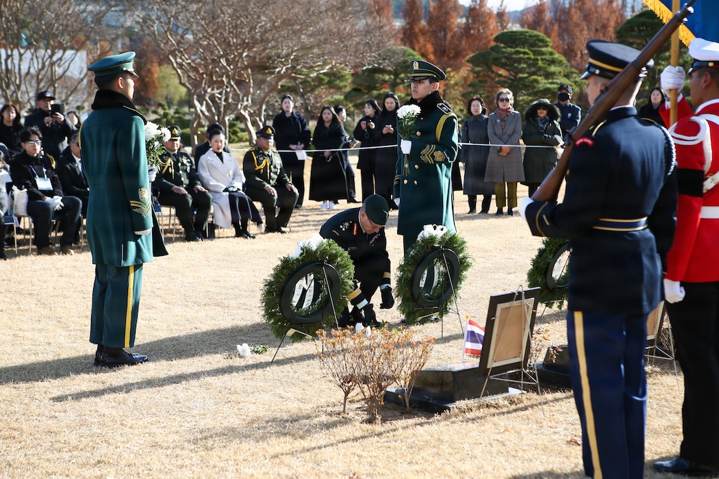 Lt. Gen. Derek Macaulay, United Nations Command deputy commander, places a white chrysanthemum at the grave marker of the two Thai veterans during the interment ceremony at the United Nations Memorial Cemetery in Korea, Dec. 12.