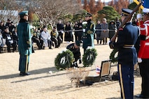 Lt. Gen. Derek Macaulay, United Nations Command deputy commander, places a white chrysanthemum at the grave marker of the two Thai veterans during the interment ceremony at the United Nations Memorial Cemetery in Korea, Dec. 12.