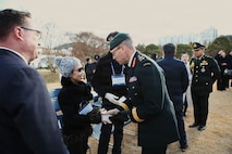 Lt. Gen. Derek Macaulay, United Nations Command deputy commander, greets a family member of one of the honored Thai service members before the interment ceremony at the United Nations Memorial Cemetery in Korea, Dec. 12.