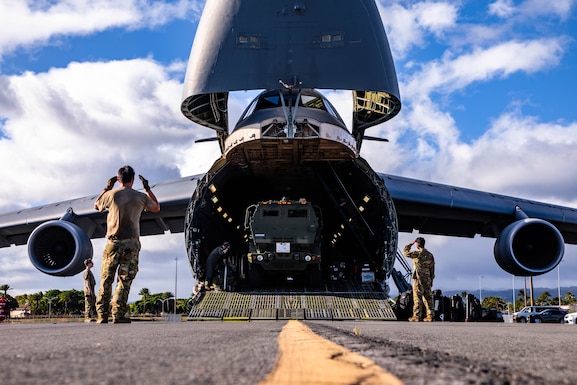 Airmen unload High Mobility Artillery Rocket System (HIMARS) launchers from a U.S. Air Force C-5 Galaxy at Joint Base Pearl Harbor-Hickam, July 14, 2025.