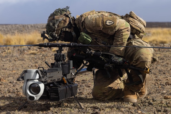 U.S. Army Soldier Pfc. Eric Rivera, assigned to Delta Troop, 1st Platoon, Multipurpose Company, 3rd Squadron, 4th Cavalry Regiment, 3rd Mobile Brigade, 25th Infantry Division, approaches the Ghost-X drone to power it on before a reconnaissance mission.