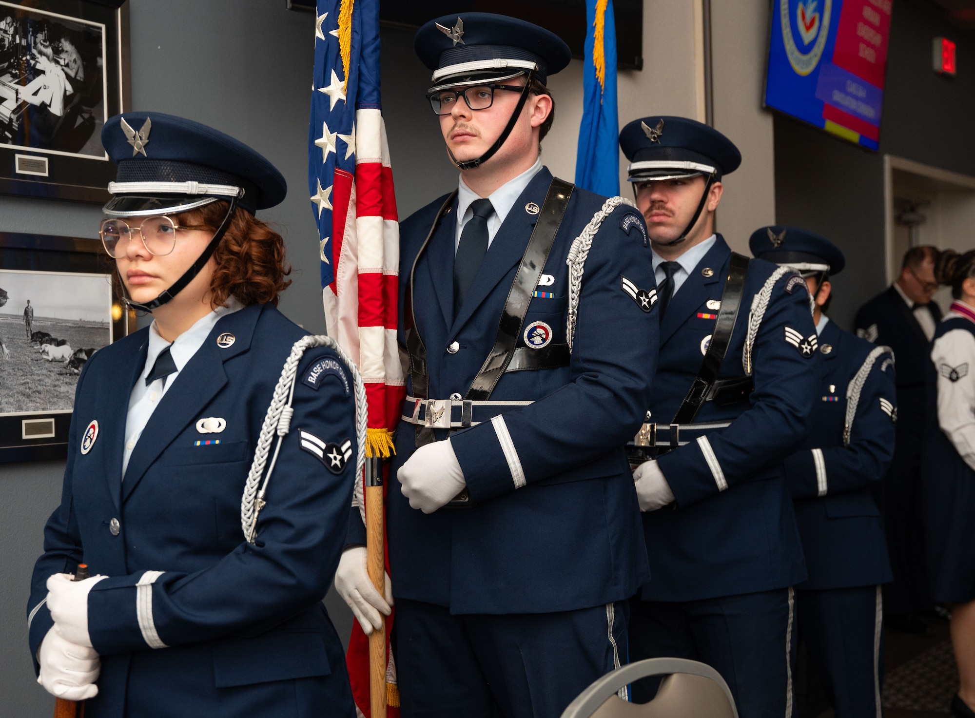Honor guard members stand still in a straight line for the presentation of colors.