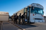 Students of Airmen Leadership School Class 26 Alpha board a bus to the field training exercise area on Dec. 12, 2025 at Altus Air Force Base, Oklahoma. The field training exercise required students to operate outside their primary specialties, leading teams composed of members from diverse career fields. (U.S. Air Force photo by Staff Sgt. Cody Dowell)