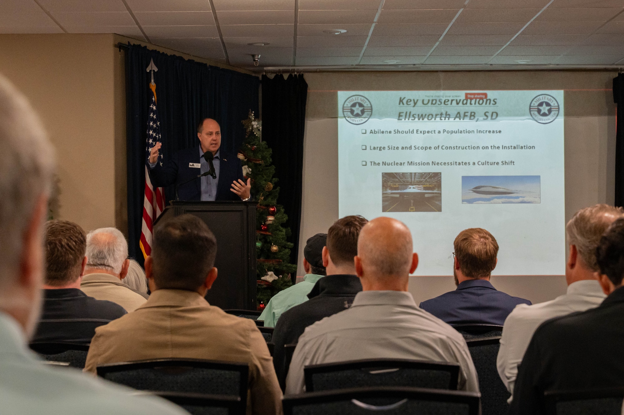 John Nichols, Abilene Chamber of Commerce Military Affairs Council vice president, addresses industry partners during the B-21 Industry Day at Dyess Air Force Base, Texas, Dec. 12, 2025.  The event provided a forum to discuss upcoming military construction opportunities, strengthening collaboration as Dyess prepares to become the third Main Operating Base for the B-21 Raider. (U.S. Air Force photo by Airman William Neal)