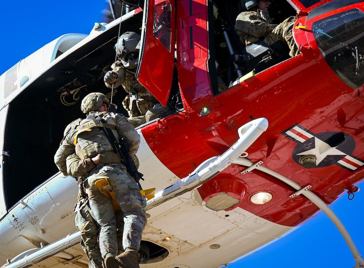 Airmen are lifted into a 413th Flight Test Squadron UH-1 Huey during a two-day mission-ready training event at Eglin Air Force Base, Fla., Dec. 12, 2025. Conducted by the 96th Mission Support Group, the training focused on weapons familiarization and tactical movement techniques designed to enhance coordination, readiness and response capabilities in realistic operational scenarios. (U.S. Air Force photo by 2nd Lt. Jose Garcia) 