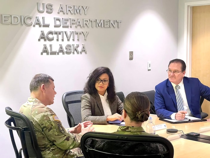 Image of people sitting at a table talking.