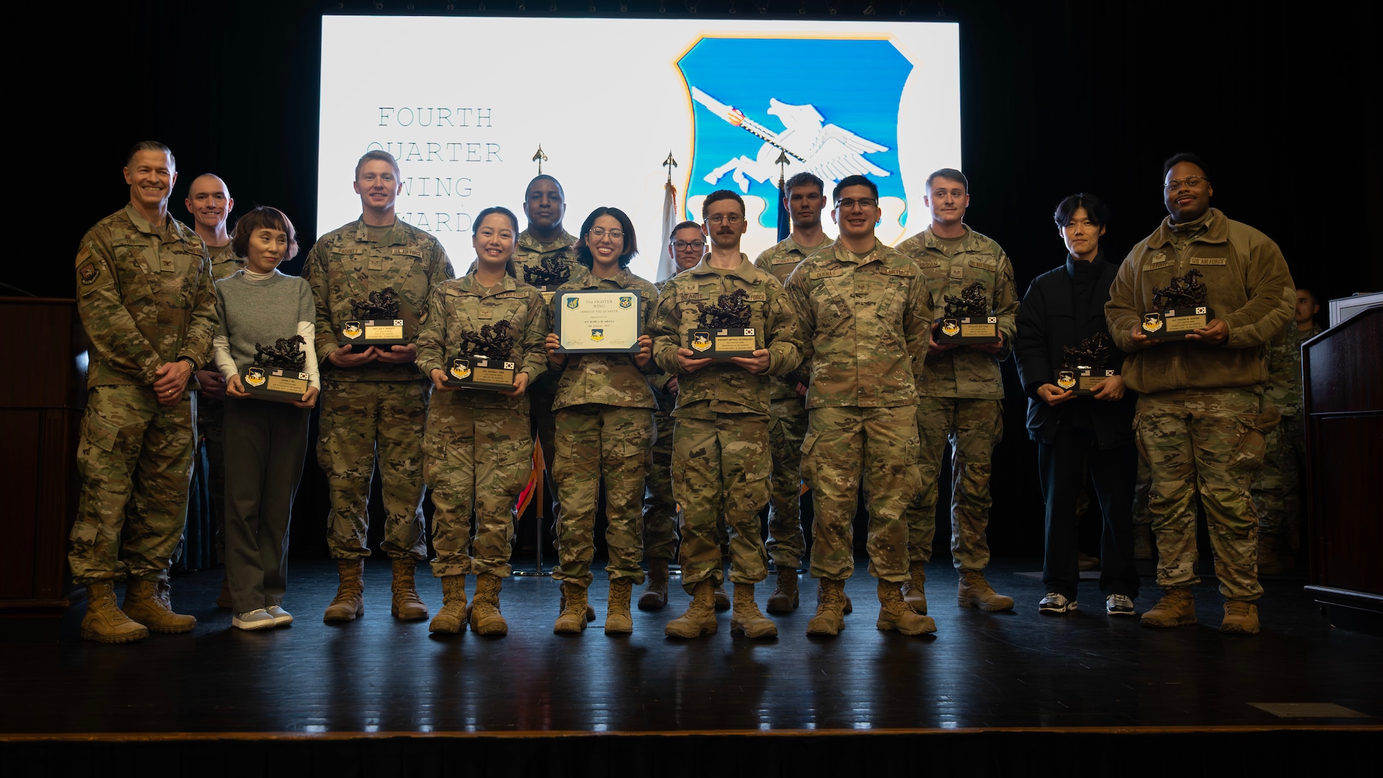 Award winners pose for a group photo during the 4th Quarter Awards at Osan Air Base, Republic of Korea, Dec. 17, 2025. Their professionalism, dedication, and commitment to excellence continues to strengthen Osan's readiness and keeps us ready to Fight Tonight. (U.S. Air Force photo by Staff Sgt. Sarah Williams)