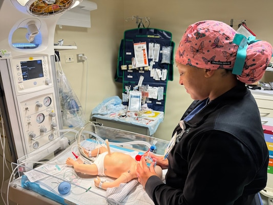 Hospital Corpsman 2nd Class Jazmine Strain, a respiratory therapist assigned to Naval Medical Readiness and Training Command (NMRTC) Sigonella, participates in the Neonatal Resuscitation Program in the naval hospital’s main operating room. As a clinician who responds to deliveries, ongoing participation in NRP ensures continued proficiency and confidence in managing neonatal resuscitation emergencies at birth.