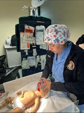 Hospital Corpsman 3rd Class Ellison Robinson, a respiratory therapist assigned to Naval Medical Readiness and Training Command (NMRTC) Sigonella, participates in the Neonatal Resuscitation Program in the naval hospital’s main operating room. As a clinician who responds to deliveries, ongoing participation in NRP ensures continued proficiency and confidence in managing neonatal resuscitation emergencies at birth.