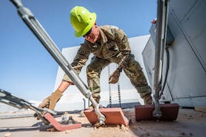 U.S. Air Force Senior Airman Austin Kirk, and Airman 1st Class Sean Stark, 378th Expeditionary Civil Engineer Squadron structural maintenance journeymen, inspect tension fabric systems on large area maintenance shelters