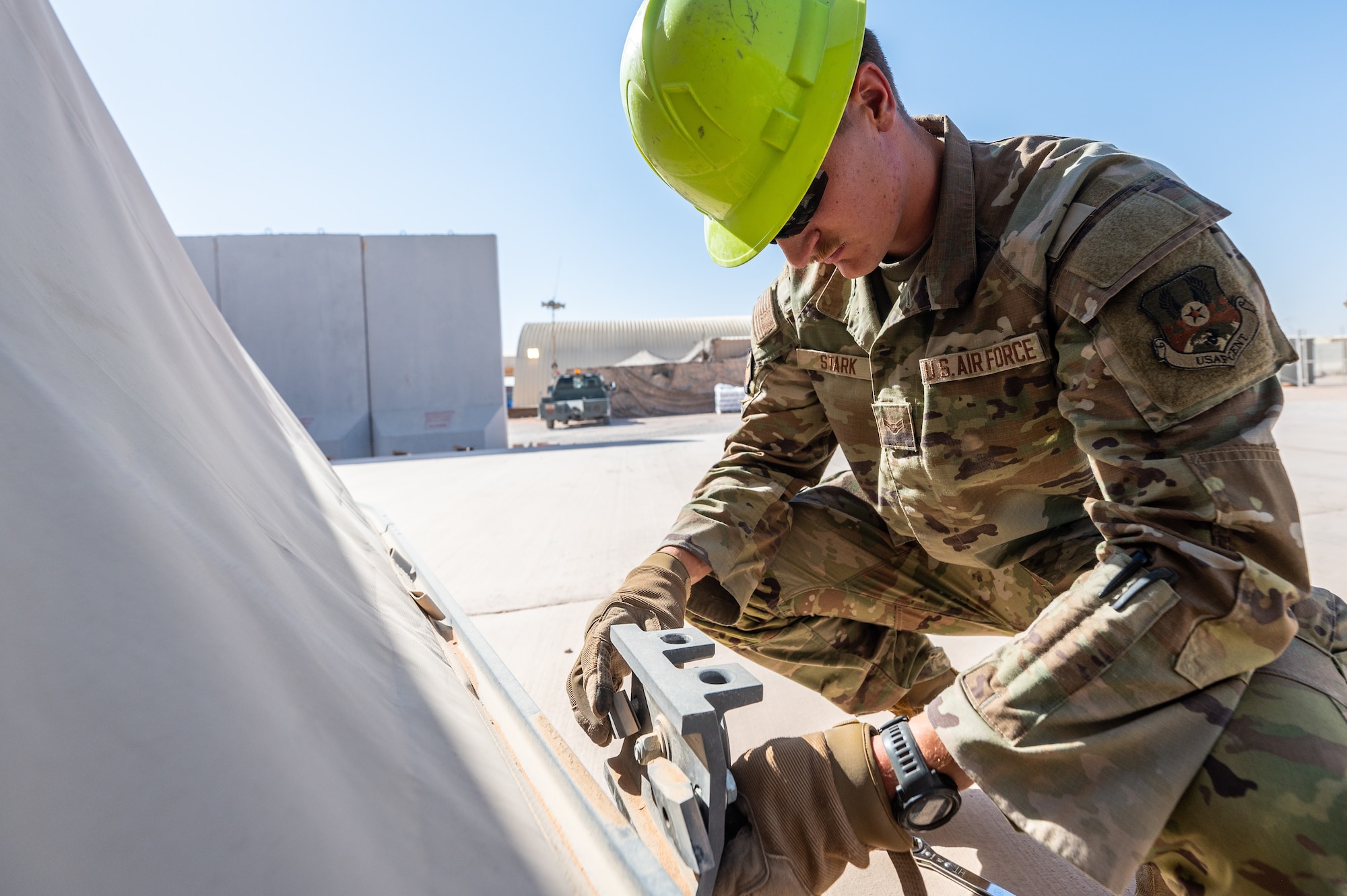 U.S. Air Force Senior Airman Austin Kirk, and Airman 1st Class Sean Stark, 378th Expeditionary Civil Engineer Squadron structural maintenance journeymen, inspect tension fabric systems on large area maintenance shelters
