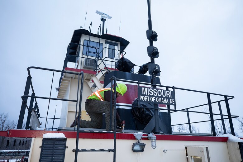 A photo of eingines being removed from a towboat.