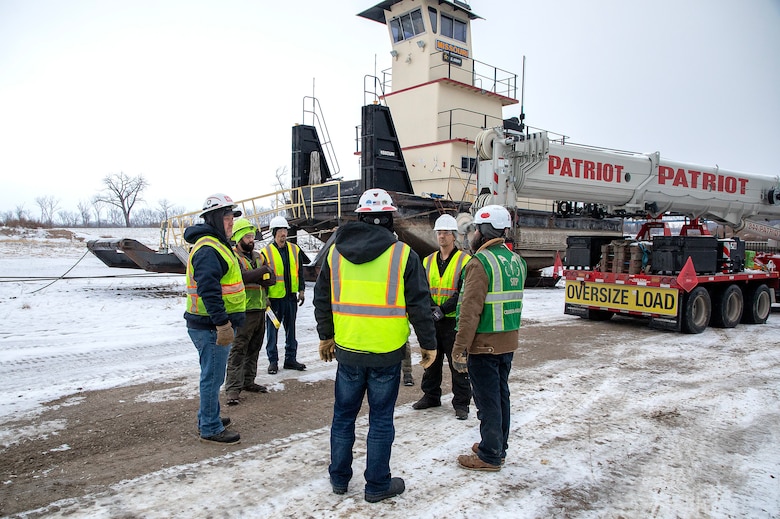 A photo of eingines being removed from a towboat.