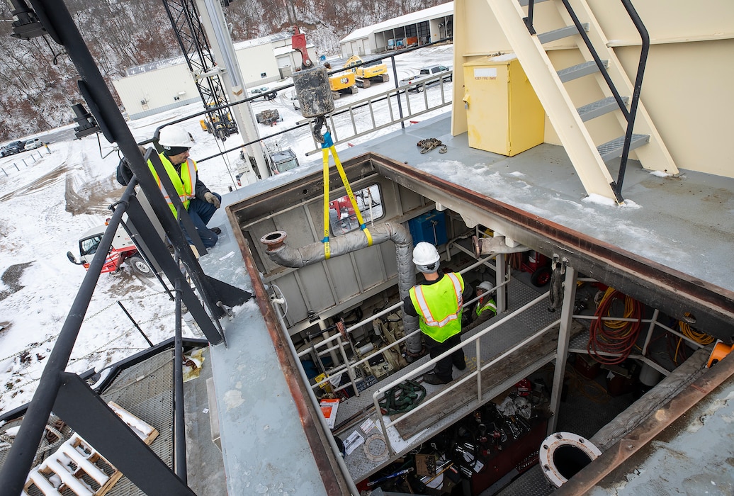 A photo of eingines being removed from a towboat.
