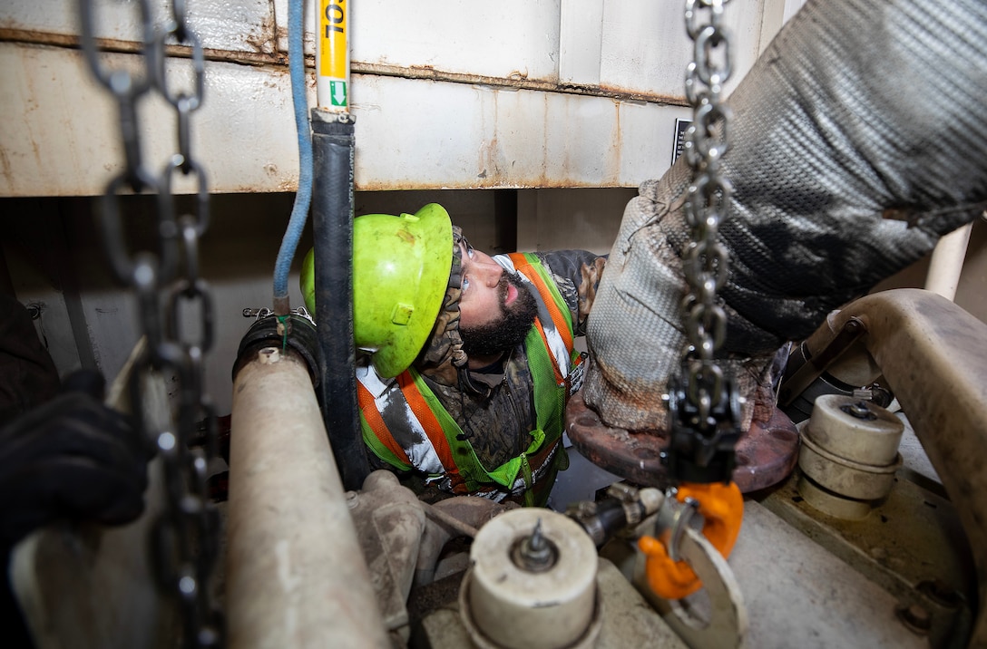 A photo of eingines being removed from a towboat.