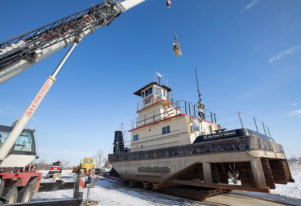 A photo of eingines being removed from a towboat.