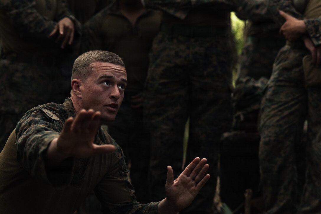 U.S. Marine Corps Staff Sgt. Justin Dixon, a platoon sergeant with Weapons Company, Battalion Landing Team 3rd Battalion, 1st Marine Regiment, 31st Marine Expeditionary Unit, conducts a terrain model brief during a simulated tactical recovery of aircraft personnel exercise as part of MEU Exercise at Camp Schwab, Okinawa, Japan, Dec. 10, 2025. The simulated TRAP exercise showcased advanced trauma life support capabilities and evaluated the platoon’s rapid response and recovery tactics of downed aircraft, personnel and equipment in isolated locations. The 31st MEU, the Marine Corps’ only continuously forward deployed MEU, provides a flexible and lethal force, ready to perform a wide range of military operations as the premiere crisis response force in the Indo-Pacific region. Dixon is a native of Delaware. (U.S. Marine Corps photo by Sgt. Alora Finigan)