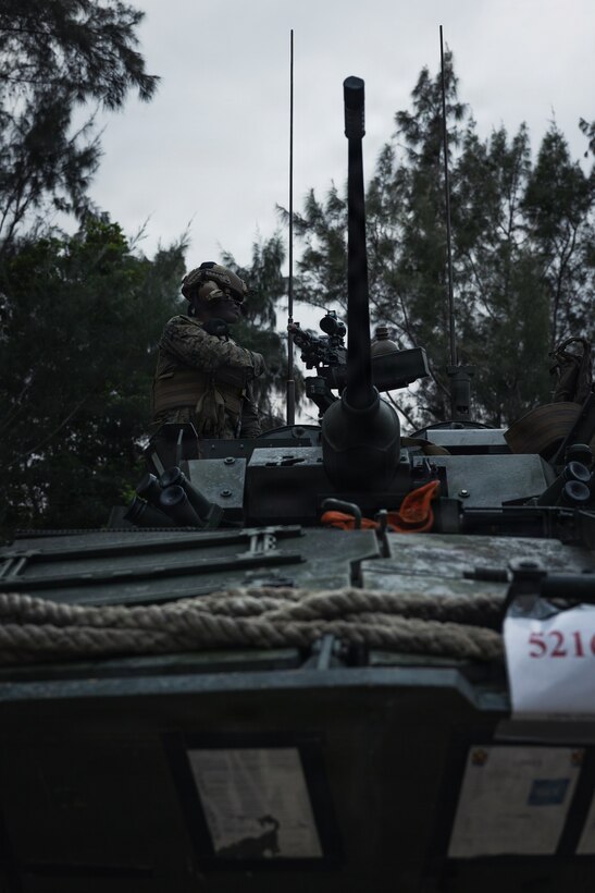 U.S. Marines Corps Staff Sgt. Louis Moore, a light armored vehicle crewman with Weapons Company, Battalion Landing Team 3rd Battalion, 1st Marine Regiment, 31st Marine Expeditionary Unit, conducts a communication check during a simulated tactical recovery of aircraft personnel exercise as part of MEU Exercise at Camp Schwab, Okinawa, Japan, Dec. 10, 2025. The simulated TRAP exercise showcased advanced trauma life support capabilities and evaluated the platoon’s rapid response and recovery tactics of downed aircraft, personnel and equipment in isolated locations. The 31st MEU, the Marine Corps’ only continuously forward deployed MEU, provides a flexible and lethal force, ready to perform a wide range of military operations as the premiere crisis response force in the Indo-Pacific region. Moore is a native of South Carolina. (U.S. Marine Corps photo by Sgt. Alora Finigan)