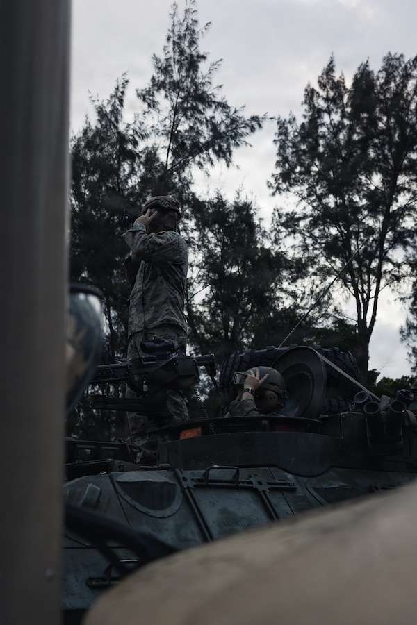 U.S. Marines with Weapons Company, Battalion Landing Team 3rd Battalion, 1st Marine Regiment, 31st Marine Expeditionary Unit, conduct a communication check during a simulated tactical recovery of aircraft personnel exercise as part of MEU Exercise at Camp Schwab, Okinawa, Japan, Dec. 10, 2025. The simulated TRAP exercise showcased advanced trauma life support capabilities and evaluated the platoon’s rapid response and recovery tactics of downed aircraft, personnel and equipment in isolated locations. The 31st MEU, the Marine Corps’ only continuously forward deployed MEU, provides a flexible and lethal force, ready to perform a wide range of military operations as the premiere crisis response force in the Indo-Pacific region. (U.S. Marine Corps photo by Sgt. Alora Finigan)