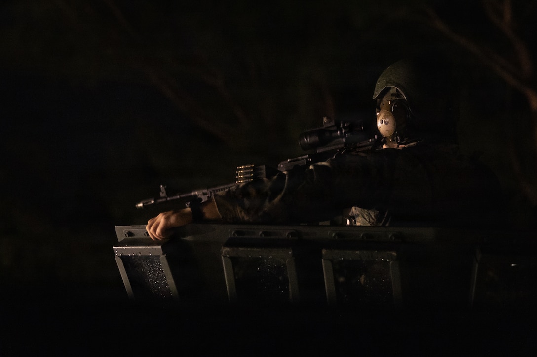A U.S. Marine with Weapons Company, Battalion Landing Team 3rd Battalion, 1st Marine Regiment, 31st Marine Expeditionary Unit, prepares a light armored vehicle for convoy operations during a simulated tactical recovery of aircraft personnel exercise as part of MEU Exercise at Camp Schwab, Okinawa, Japan, Dec. 10, 2025. The simulated TRAP exercise showcased advanced trauma life support capabilities and evaluated the platoon’s rapid response and recovery tactics of downed aircraft, personnel and equipment in isolated locations. The 31st MEU, the Marine Corps’ only continuously forward deployed MEU, provides a flexible and lethal force, ready to perform a wide range of military operations as the premiere crisis response force in the Indo-Pacific region. (U.S. Marine Corps photo by Sgt. Alora Finigan)