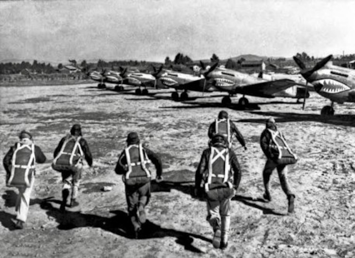 U.S. pilots assigned to the American Volunteer Group run toward their Curtiss P-40 Warhawk fighters to board for a mission in China.