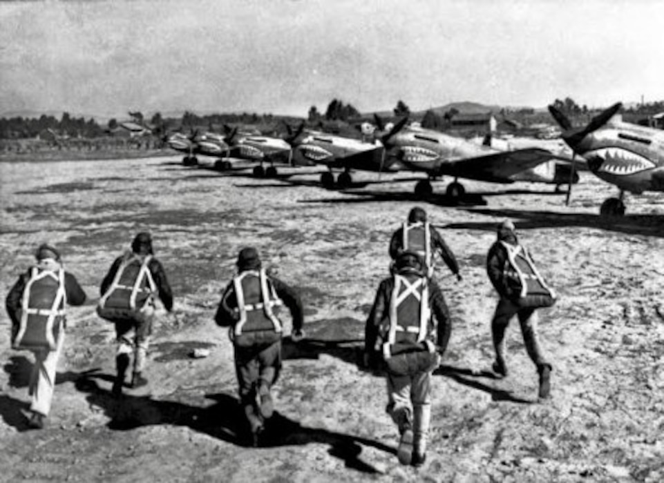 U.S. pilots assigned to the American Volunteer Group run toward their Curtiss P-40 Warhawk fighters to board for a mission in China.