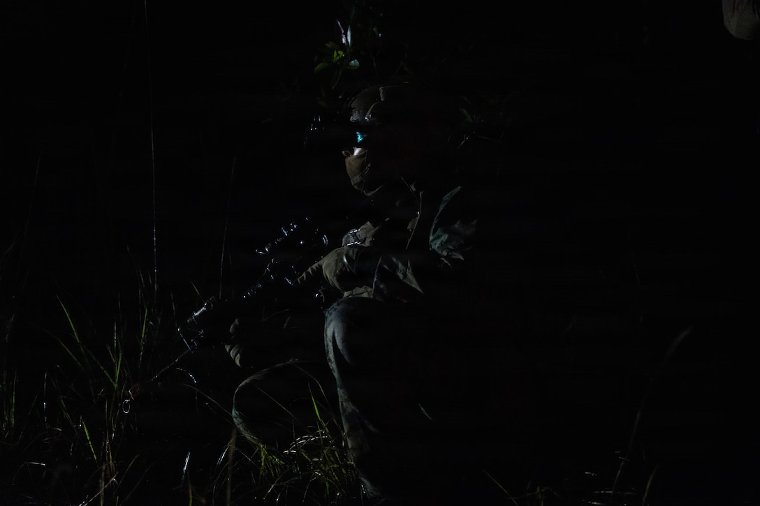 A U.S. Marine with Weapons Company, Battalion Landing Team 3rd Battalion, 1st Marine Regiment, 31st Marine Expeditionary Unit, sets security during a simulated tactical recovery of aircraft personnel exercise as part of MEU Exercise at Camp Schwab, Okinawa, Japan, Dec. 10, 2025. The simulated TRAP exercise showcased advanced trauma life support capabilities and evaluated the platoon’s rapid response and recovery tactics of downed aircraft, personnel and equipment in isolated locations. The 31st MEU, the Marine Corps’ only continuously forward deployed MEU, provides a flexible and lethal force, ready to perform a wide range of military operations as the premiere crisis response force in the Indo-Pacific region. (U.S. Marine Corps photo by Sgt. Alora Finigan)