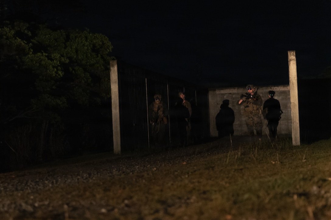 U.S. Marine with Weapons Company, Battalion Landing Team 3rd Battalion, 1st Marine Regiment, 31st Marine Expeditionary Unit, conduct a patrol during a simulated tactical recovery of aircraft personnel exercise as part of MEU Exercise at Camp Schwab, Okinawa, Japan, Dec. 10, 2025. The simulated TRAP exercise showcased advanced trauma life support capabilities and evaluated the platoon’s rapid response and recovery tactics of downed aircraft, personnel and equipment in isolated locations. The 31st MEU, the Marine Corps’ only continuously forward deployed MEU, provides a flexible and lethal force, ready to perform a wide range of military operations as the premiere crisis response force in the Indo-Pacific region. (U.S. Marine Corps photo by Sgt. Alora Finigan)
