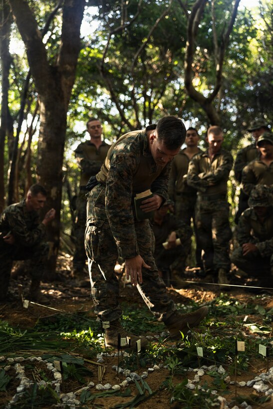 U.S. Marine Corps 1st Lt. James Naftel, an infantry officer with Weapons Company, Battalion Landing Team 3rd Battalion, 1st Marine Regiment, 31st Marine Expeditionary Unit, conducts a terrain model brief during a simulated tactical recovery of aircraft personnel exercise as part of MEU Exercise at Camp Schwab, Okinawa, Japan, Dec. 10, 2025. The simulated TRAP exercise showcased advanced trauma life support capabilities and evaluated the platoon’s rapid response and recovery tactics of downed aircraft, personnel and equipment in isolated locations. The 31st MEU, the Marine Corps’ only continuously forward deployed MEU, provides a flexible and lethal force, ready to perform a wide range of military operations as the premiere crisis response force in the Indo-Pacific region. Naftel is a native of Tennessee. (U.S. Marine Corps photo by Sgt. Alora Finigan)