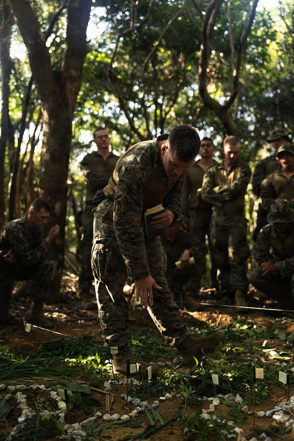 U.S. Marine Corps 1st Lt. James Naftel, an infantry officer with Weapons Company, Battalion Landing Team 3rd Battalion, 1st Marine Regiment, 31st Marine Expeditionary Unit, conducts a terrain model brief during a simulated tactical recovery of aircraft personnel exercise as part of MEU Exercise at Camp Schwab, Okinawa, Japan, Dec. 10, 2025. The simulated TRAP exercise showcased advanced trauma life support capabilities and evaluated the platoon’s rapid response and recovery tactics of downed aircraft, personnel and equipment in isolated locations. The 31st MEU, the Marine Corps’ only continuously forward deployed MEU, provides a flexible and lethal force, ready to perform a wide range of military operations as the premiere crisis response force in the Indo-Pacific region. Naftel is a native of Tennessee. (U.S. Marine Corps photo by Sgt. Alora Finigan)