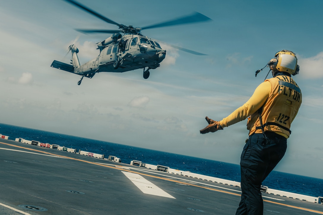 A MH-60S Knighthawk assigned to Helicopter Sea Combat (HSC) Detachment, prepares to land aboard the forward-deployed amphibious assault carrier USS Tripoli (LHA 7), flagship of the Tripoli Expeditionary Strike Group, Dec. 7, 2025, while conducting routine operations in the U.S. 7th Fleet Area of Operations. The 31st MEU, the Marine Corps’ only continuously forward-deployed MEU, provides a flexible and lethal force ready to perform a wide range of military operations as the premiere crisis response force in the Indo-Pacific region. (U.S. Marine Corps photo by Lance Cpl. Raul Sotovilla)
