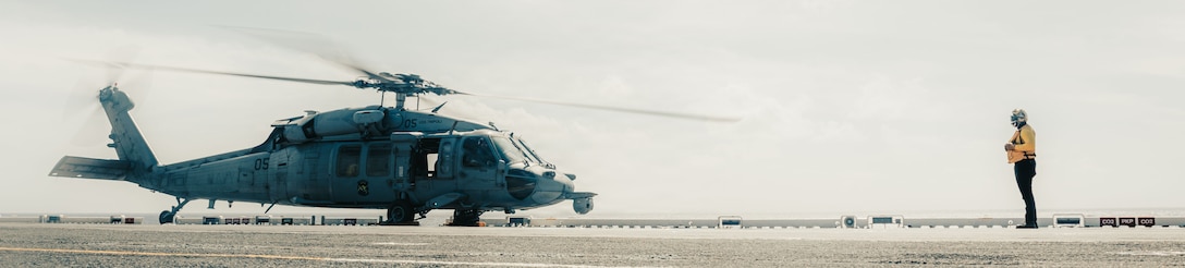A MH-60S Knighthawk assigned to Helicopter Sea Combat (HSC) Detachment, prepares to take off aboard the forward-deployed amphibious assault carrier USS Tripoli (LHA 7), flagship of the Tripoli Expeditionary Strike Group, Dec. 7, 2025, while conducting routine operations in the U.S. 7th Fleet Area of Operations. The 31st MEU, the Marine Corps’ only continuously forward-deployed MEU, provides a flexible and lethal force ready to perform a wide range of military operations as the premiere crisis response force in the Indo-Pacific region. (U.S. Marine Corps photo by Lance Cpl. Raul Sotovilla)