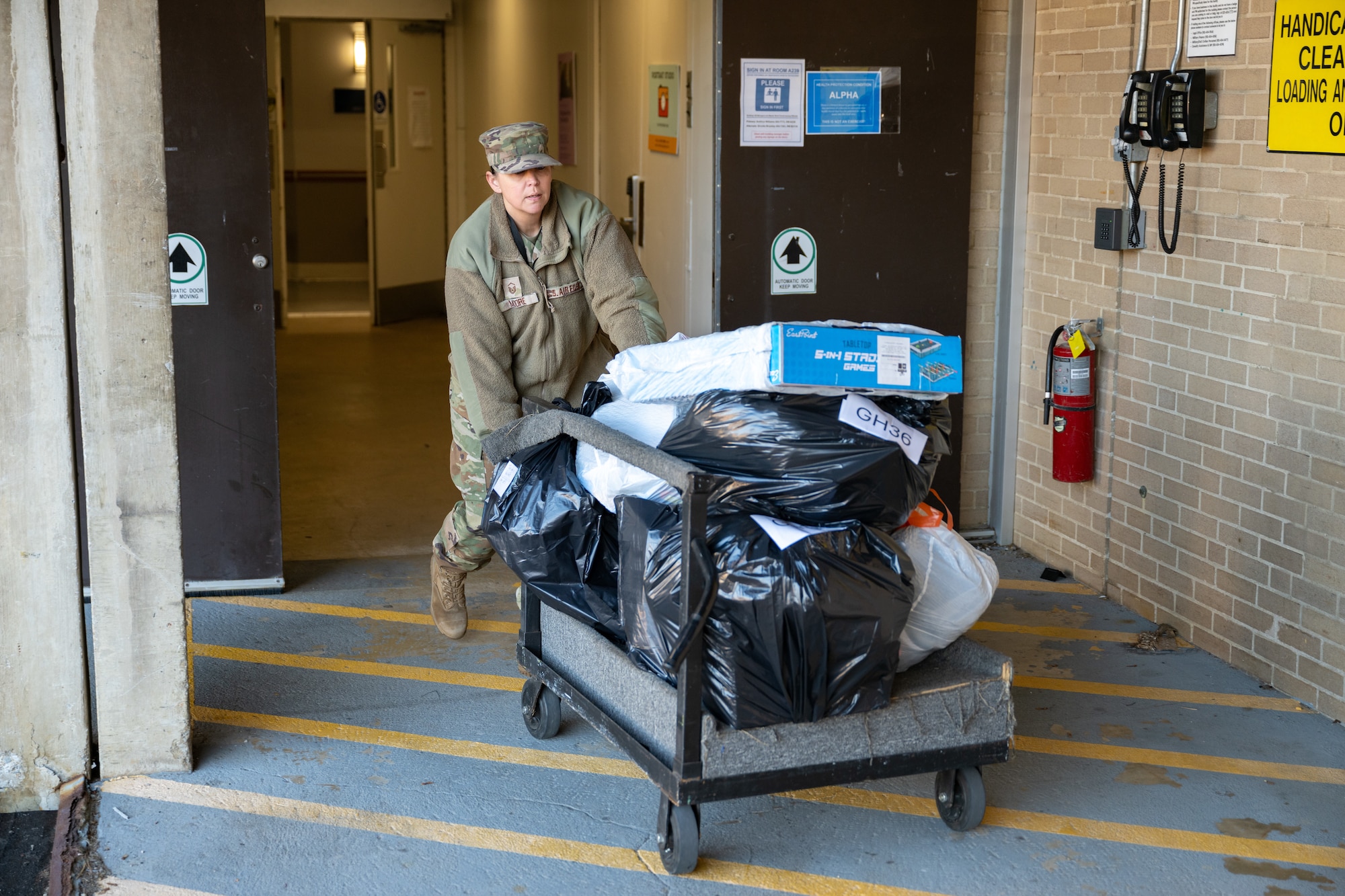 Master Sgt. Nicki Moore transports for pickup by a local charity some of the items purchased by Arnold AFB team members through the Project Christmas program. This year, 105 children were sponsored and will receive gifts from Arnold personnel. (U.S. Air Force photo by Keith Thornburgh)