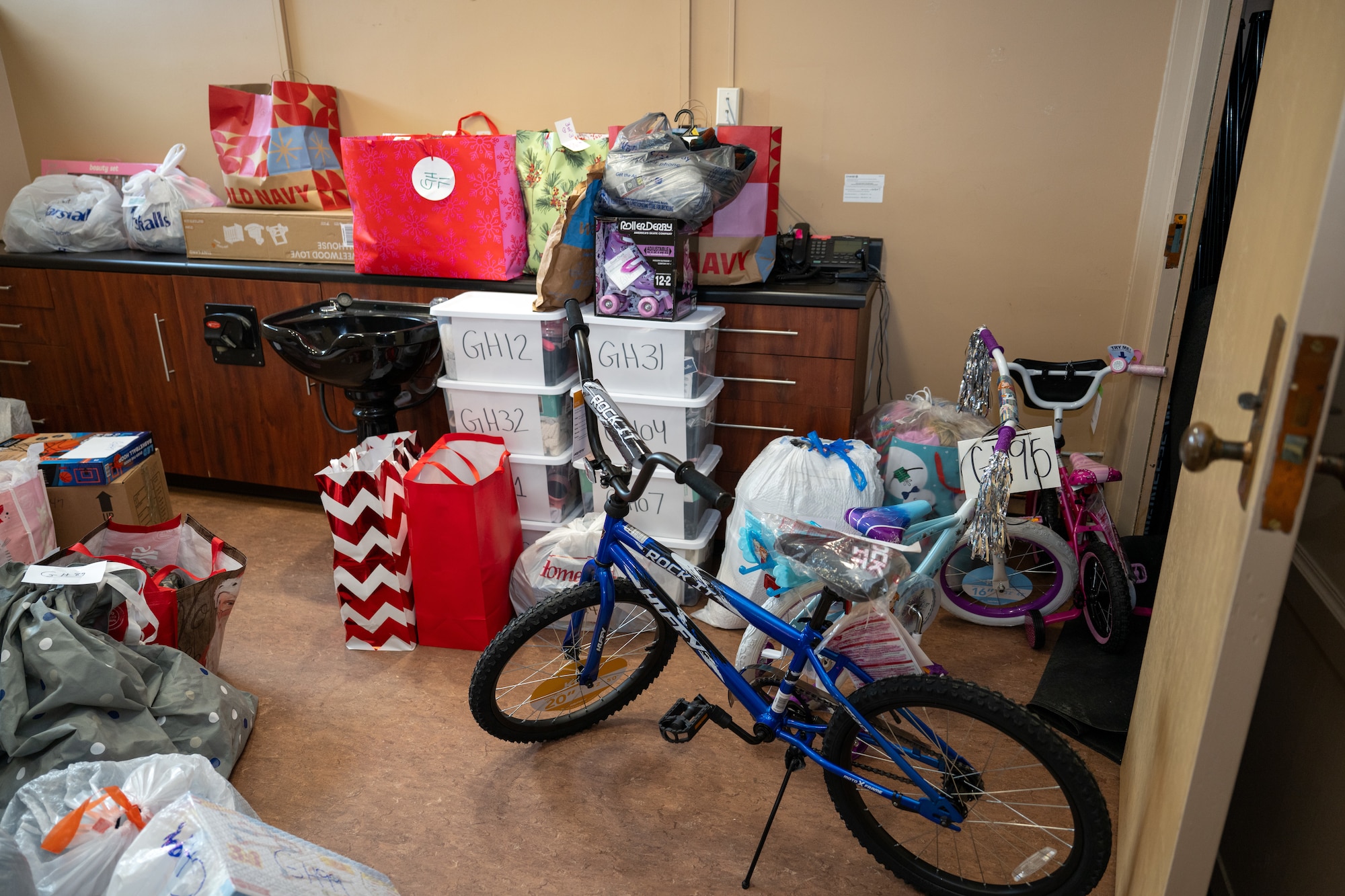 Bags stuffed with toys and clothing await collection at Arnold Air Force Base, Tenn., Dec. 9, 2025. The items were purchased by Arnold AFB team members through the Project Christmas gift drive. This year, 105 children were sponsored and will receive gifts from Arnold personnel. (U.S. Air Force photo by Keith Thornburgh)