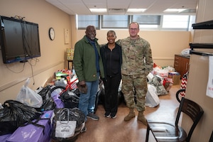 Tech Sgt. Jason Wiggins, right, who led this year’s Project Christmas gift drive effort at Arnold Air Force Base, Tenn., poses for a photo with Grams Community Network Founder and CEO Lashonda Morehead, center, and Neail Tyson. This year, 105 children were sponsored and will receive gifts from Arnold personnel. (U.S. Air Force photo by Keith Thornburgh)