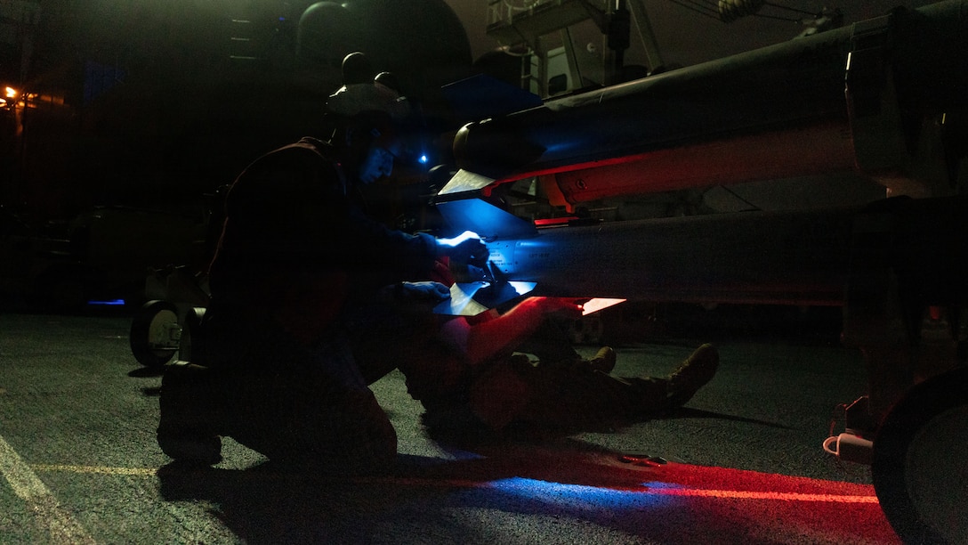 U.S. Marines with Marine Fighter Attack Squadron (VMFA) 242, 31st Marine Expeditionary Unit, prepare to load ordinance onto an F-35B Lightning II aboard the forward-deployed amphibious assault carrier USS Tripoli (LHA 7), flagship of the Tripoli Expeditionary Strike Group, Dec. 7, 2025, while conducting routine operations in the U.S. 7th Fleet Area of Operations. The 31st MEU, the Marine Corps’ only continuously forward-deployed MEU, provides a flexible and lethal force ready to perform a wide range of military operations as the premiere crisis response force in the Indo-Pacific region. (U.S. Marine Corps photo by Lance Cpl. Raul Sotovilla)