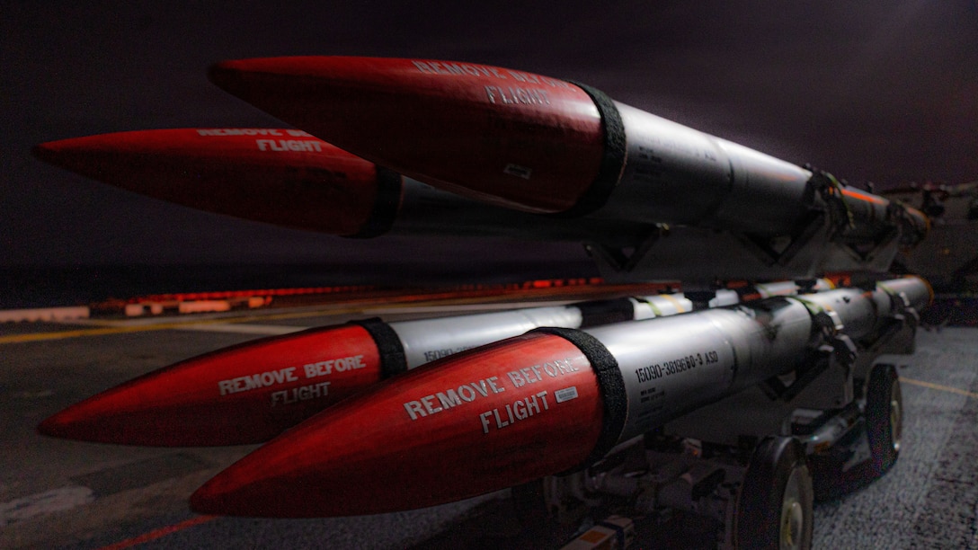 U.S. Marines with Marine Fighter Attack Squadron (VMFA) 242, 31st Marine Expeditionary Unit, prepare to load ordinance onto an F-35B Lightning II aboard the forward-deployed amphibious assault carrier USS Tripoli (LHA 7), flagship of the Tripoli Expeditionary Strike Group, Dec. 7, 2025, while conducting routine operations in the U.S. 7th Fleet Area of Operations. The 31st MEU, the Marine Corps’ only continuously forward-deployed MEU, provides a flexible and lethal force ready to perform a wide range of military operations as the premiere crisis response force in the Indo-Pacific region. (U.S. Marine Corps photo by Lance Cpl. Raul Sotovilla)