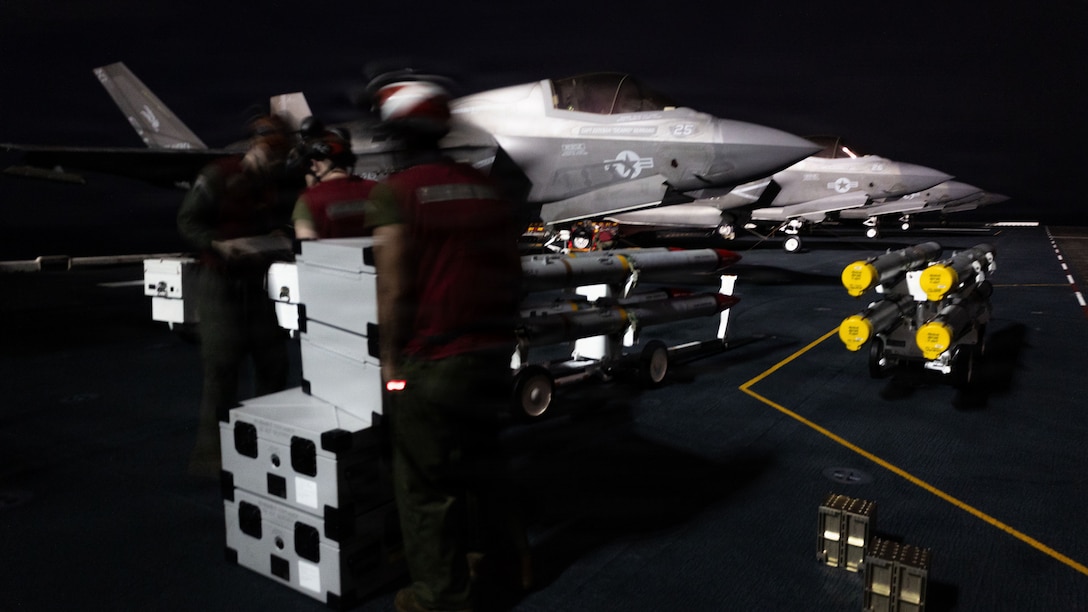 U.S. Marines with Marine Fighter Attack Squadron (VMFA) 242, 31st Marine Expeditionary Unit, prepare to load ordinance onto an F-35B Lightning II aboard the forward-deployed amphibious assault carrier USS Tripoli (LHA 7), flagship of the Tripoli Expeditionary Strike Group, Dec. 7, 2025, while conducting routine operations in the U.S. 7th Fleet Area of Operations. The 31st MEU, the Marine Corps’ only continuously forward-deployed MEU, provides a flexible and lethal force ready to perform a wide range of military operations as the premiere crisis response force in the Indo-Pacific region. (U.S. Marine Corps photo by Lance Cpl. Raul Sotovilla)