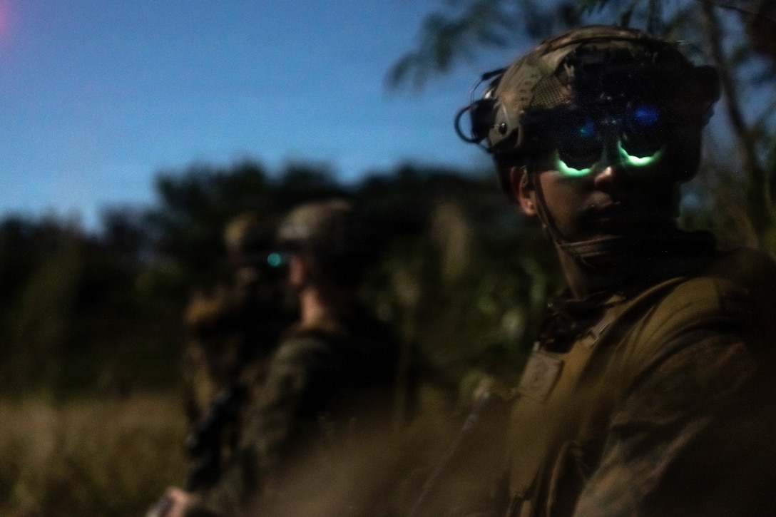 U.S. Marines with Kilo Company, Battalion Landing Team 3rd Battalion, 1st Marine Regiment, 31st Marine Expeditionary Unit, hold security while conducting a mechanized raid on Camp Hansen, Okinawa, Japan, Dec. 05, 2025. The raid was conducted to enhance efficiency and efficacy of ship-to-shore operations utilizing mechanized assets. The 31st MEU, the Marine Corps’ only continuously forward-deployed MEU, provides a flexible and lethal force ready to perform a wide range of military operations as the premiere crisis response force in the Indo-Pacific region. (U.S. Marine Corps photo by Cpl. Maksim Masloboev)