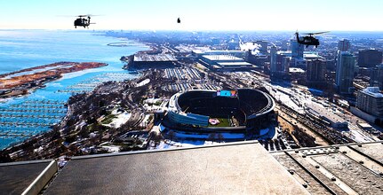 A diamond formation of Illinois Army National Guard helicopters performs a flyover over Soldier Field in Chicago on Dec. 14.