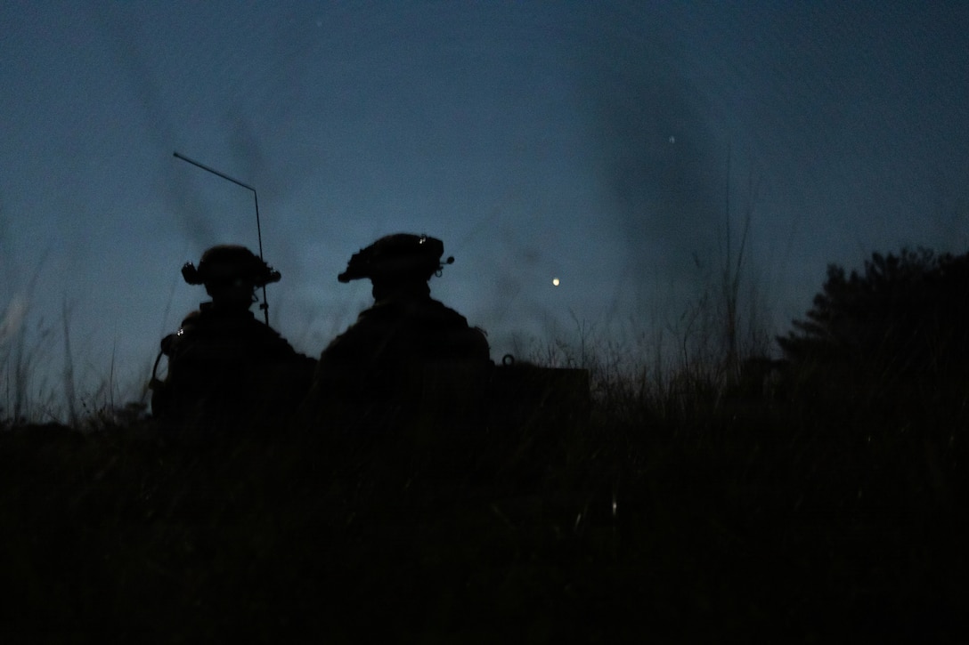 U.S. Marines with Kilo Company, Battalion Landing Team 3rd Battalion, 1st Marine Regiment, 31st Marine Expeditionary Unit, employ radio equipment during a mechanized raid on Camp Hansen, Okinawa, Japan, Dec. 05, 2025. The raid was conducted to enhance efficiency and efficacy of ship-to-shore operations utilizing mechanized assets. The 31st MEU, the Marine Corps’ only continuously forward-deployed MEU, provides a flexible and lethal force ready to perform a wide range of military operations as the premiere crisis response force in the Indo-Pacific region. (U.S. Marine Corps photo by Cpl. Maksim Masloboev)