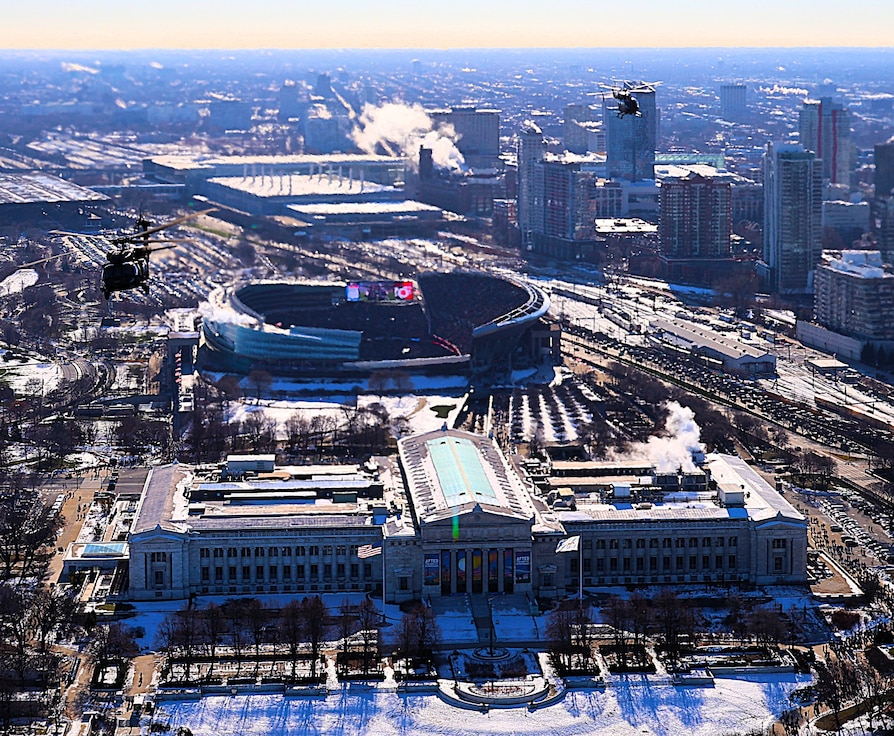 A diamond formation of Illinois Army National Guard helicopters performs a flyover over Soldier Field in Chicago on Dec. 14.