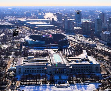 A diamond formation of Illinois Army National Guard helicopters performs a flyover over Soldier Field in Chicago on Dec. 14.