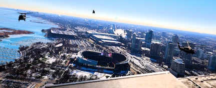 A diamond formation of Illinois Army National Guard helicopters performs a flyover over Soldier Field in Chicago on Dec. 14.