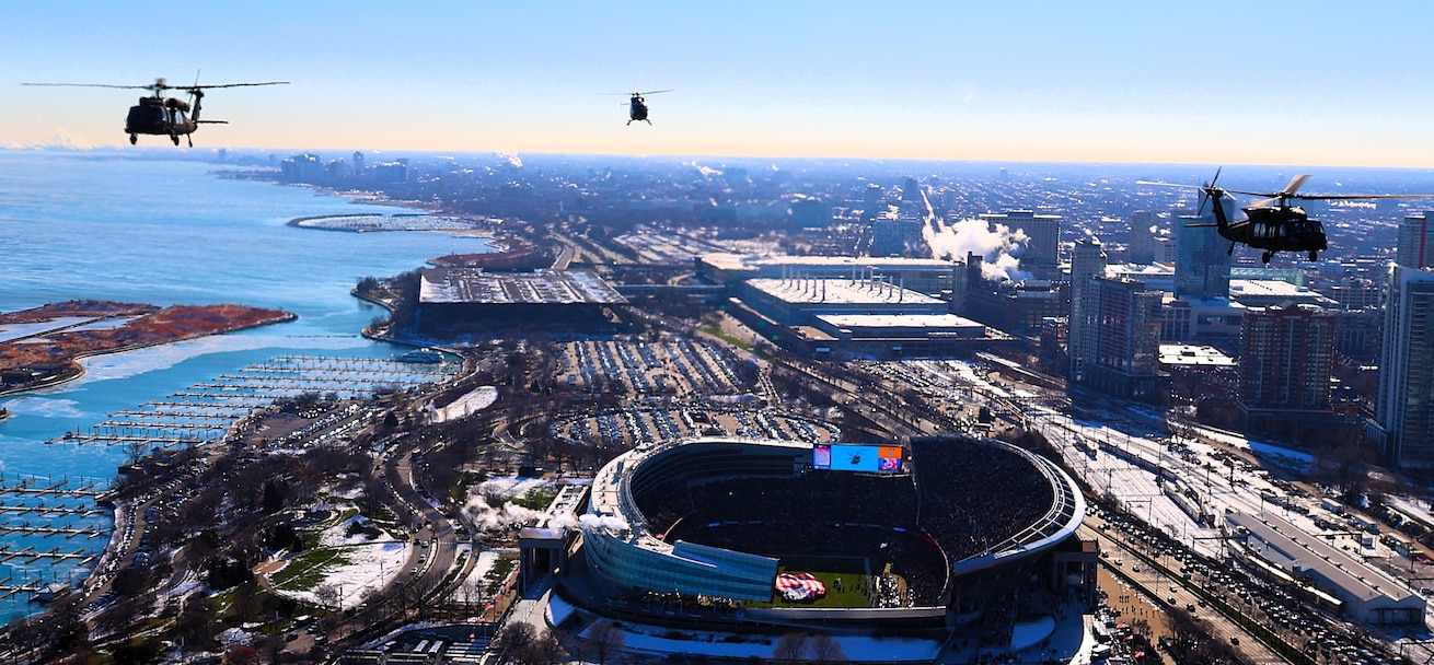 A diamond formation of Illinois Army National Guard helicopters performs a flyover over Soldier Field in Chicago on Dec. 14.