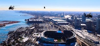 A diamond formation of Illinois Army National Guard helicopters performs a flyover over Soldier Field in Chicago on Dec. 14.