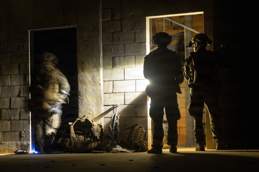 U.S. Marines with Kilo Company, Battalion Landing Team 3rd Battalion, 1st Marine Regiment, 31st Marine Expeditionary Unit, hold a defensive position after a mechanized raid on Camp Hansen, Okinawa, Japan, Dec. 05, 2025. The raid was conducted to enhance efficiency and efficacy of ship-to-shore operations utilizing mechanized assets. The 31st MEU, the Marine Corps’ only continuously forward-deployed MEU, provides a flexible and lethal force ready to perform a wide range of military operations as the premiere crisis response force in the Indo-Pacific region. (U.S. Marine Corps photo illustration by Cpl. Maksim Masloboev)
